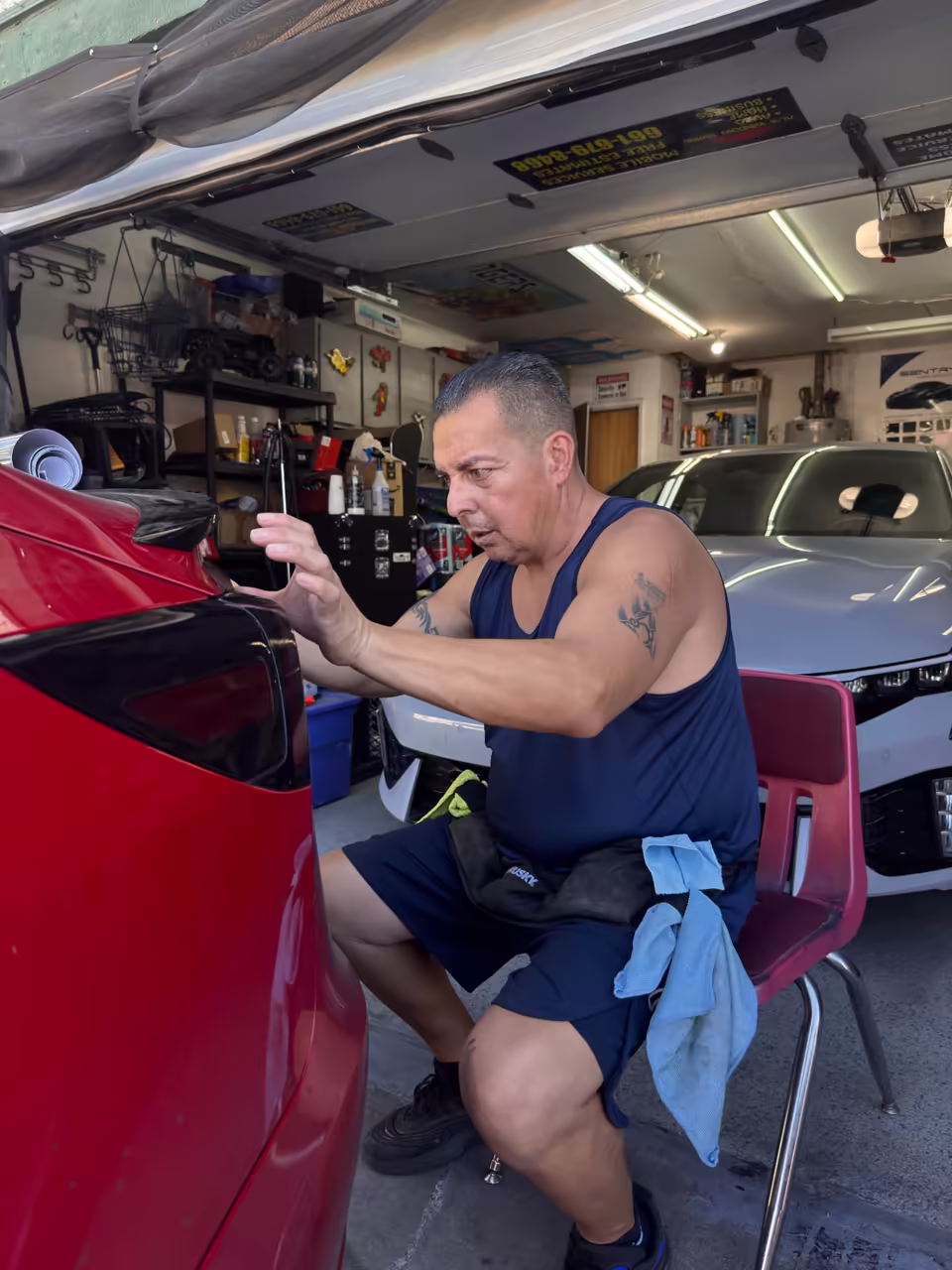 Al inspecting a tinted car at his Lancaster shop